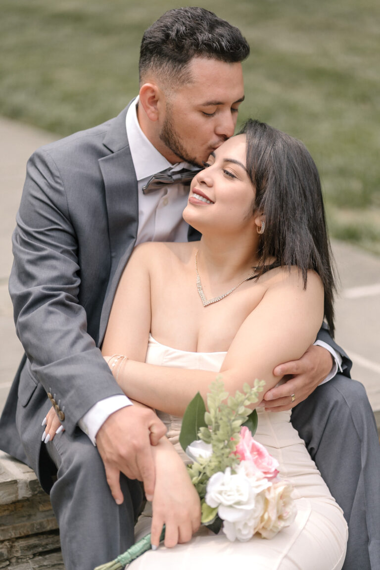 Bride and groom embracing during an intimate wedding portrait session at Brookside Gardens in Wheaton, Maryland, photographed by Kristina Yazmin Photography.