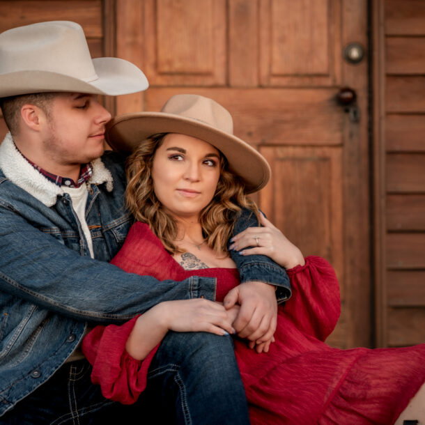 A couple embrace during their cowboy theme inspired sunset photoshoot at Manassas Battlefield Park in Virginia.