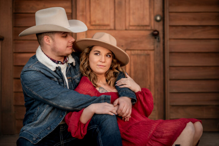 A couple embrace during their cowboy theme inspired sunset photoshoot at Manassas Battlefield Park in Virginia.