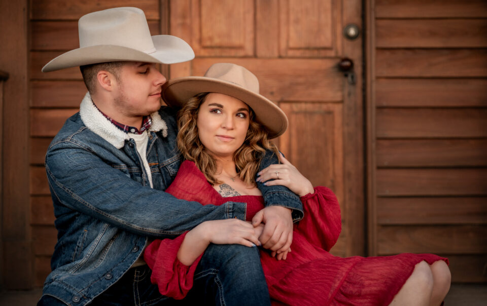 A couple embrace during their cowboy theme inspired sunset photoshoot at Manassas Battlefield Park in Virginia.