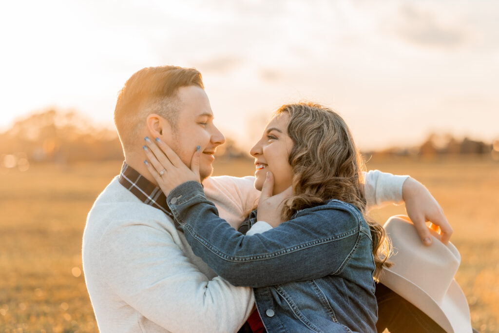 A couple embrace during their cowboy theme inspired sunset photoshoot at Manassas Battlefield Park in Virginia.